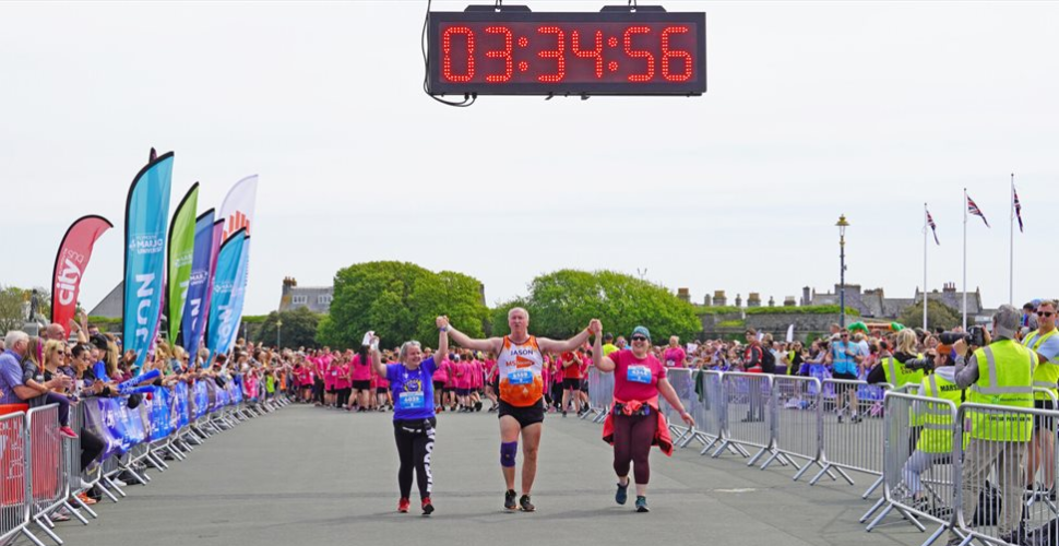 Runners cross the line at Britain's Ocean City Running Festival on Plymouth Hoe