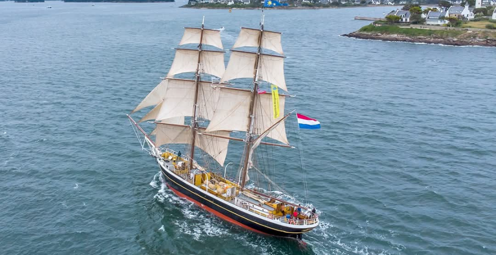 Sailing boat with a Holland flag sailing on water