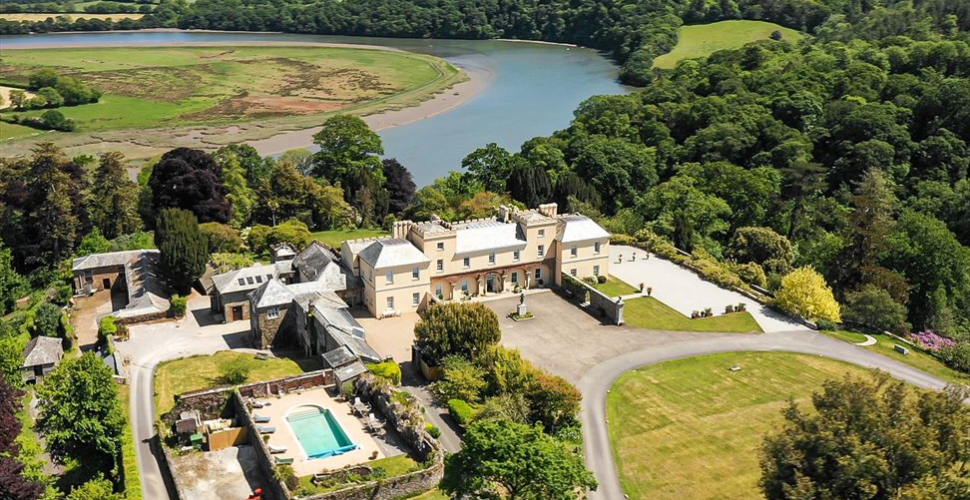Pentillie Castle and Gardens taken from above with the Tamar Estuary behind the house
