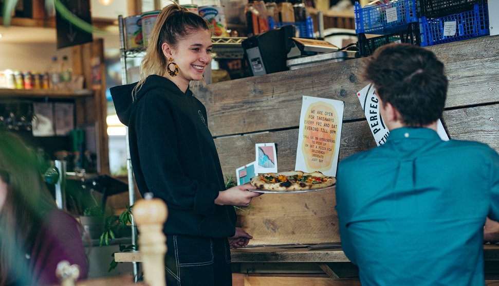 Waitress holding food at Plymouth Market