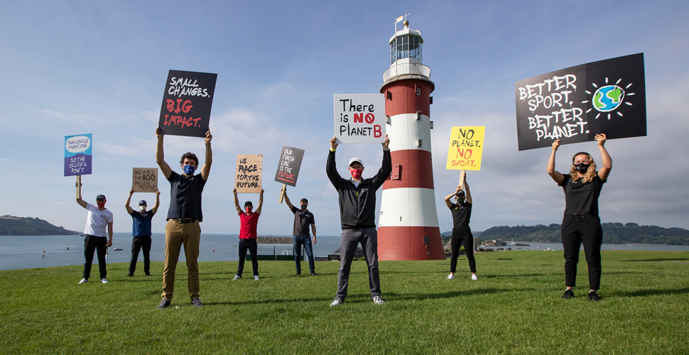 SailGP athletes campaigning with messages of hope in front of Smeaton's Tower