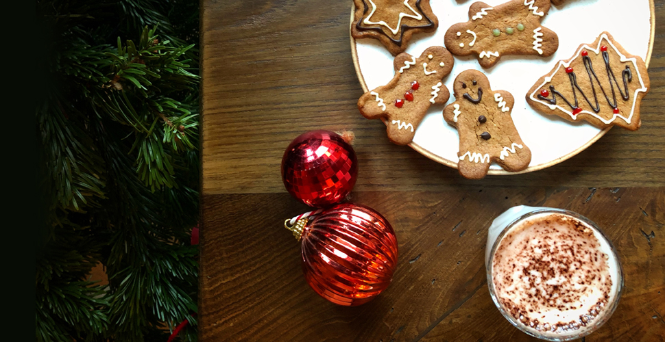 Gingerbread, bauble and hot chocolate on a table