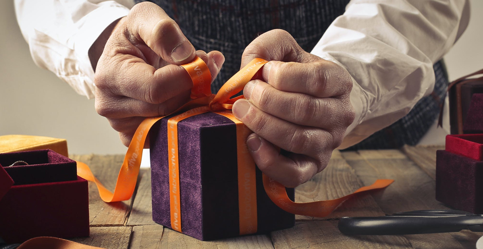 Man's hands opening a Christmas present