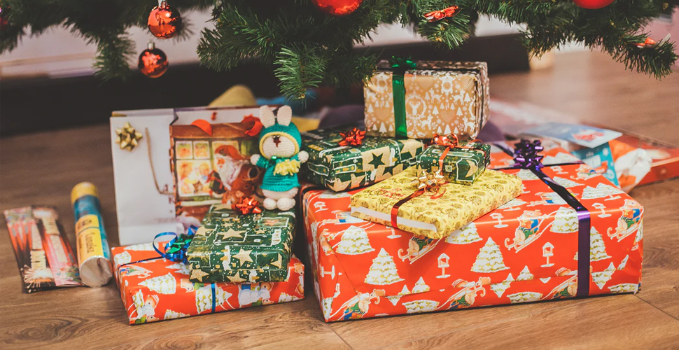 Christmas presents sitting in front of a Christmas tree