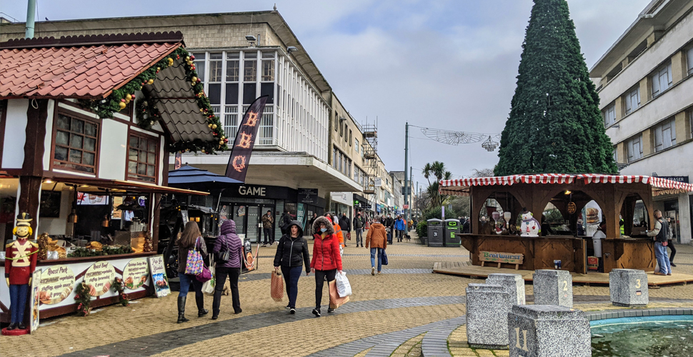 Shoppers in the city centre with Christmas stalls